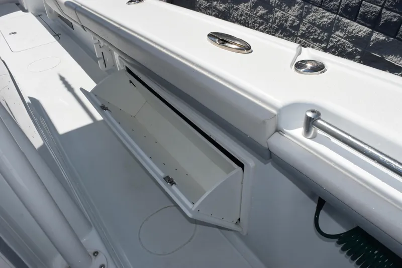 Slide: The Image of 2022 Yellowfin 34 Offshore boat interior with open storage compartment. - 28