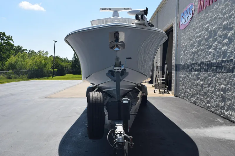 Slide: The Image of 2022 Yellowfin 34 Offshore boat on trailer outside a marine dealership. - 3