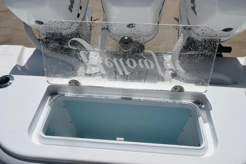 Slide: The Image of 2022 Yellowfin 34 Offshore boat with open storage compartment and wet glass panel. - 34
