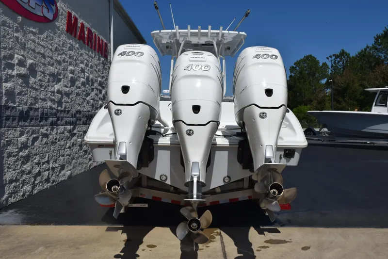 Slide: The Image of 2022 Yellowfin 34 Offshore boat with triple 400 horsepower engines, parked outdoors. - 5