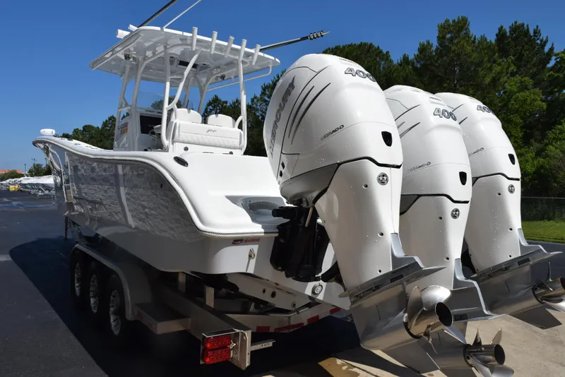 Slide: The Image of 2022 Yellowfin 34 Offshore boat with triple outboard engines on a trailer. - 6