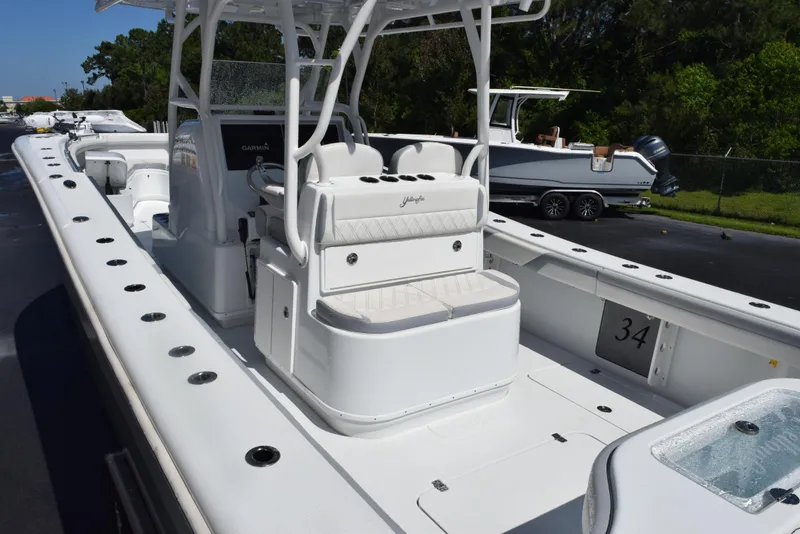 Slide: The Image of 2022 Yellowfin 34 Offshore boat, white interior, spacious deck, center console, outdoor setting. - 8