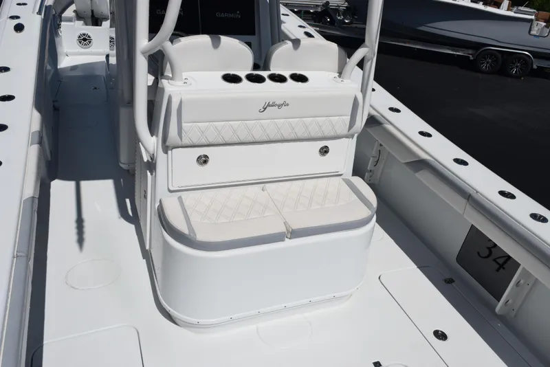 Slide: The Image of 2022 Yellowfin 34 Offshore boat interior with white seating and console. - 9