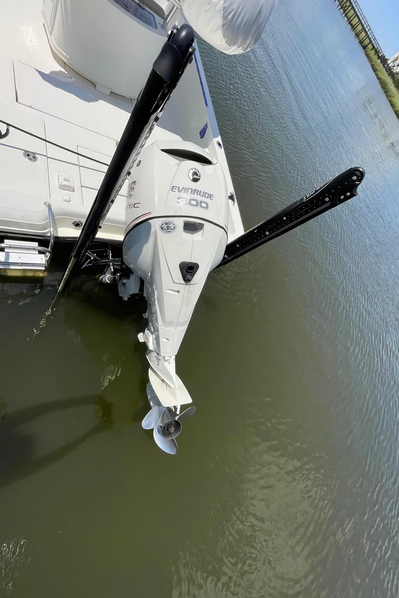 Slide: The Image of 2012 Ranger 2410 Bay Ranger boat with Evinrude motor on calm water. - 14