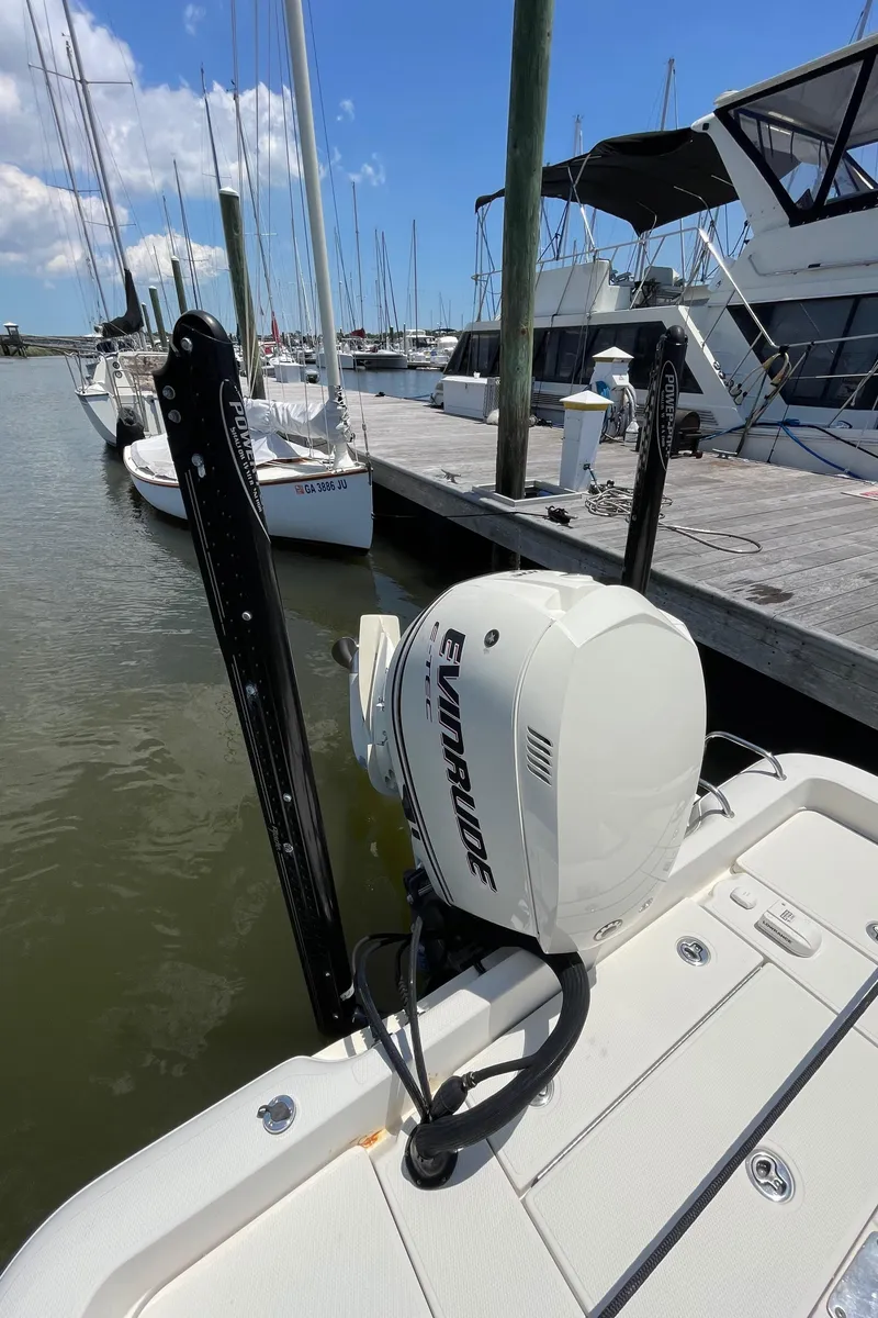 Slide: The Image of 2012 Ranger 2410 Bay Ranger boat with Evinrude motor docked at marina. - 15