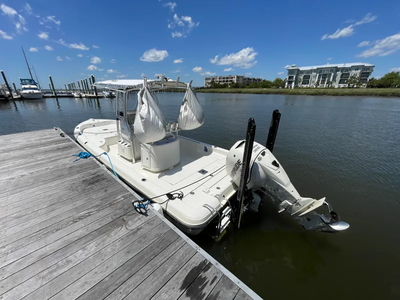 Slide: The Image of 2012 Ranger 2410 Bay Ranger boat docked on a sunny day. - 2