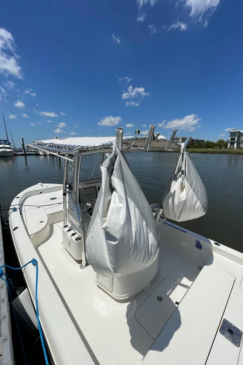 Slide: The Image of 2012 Ranger 2410 Bay Ranger boat docked under clear blue sky. - 20