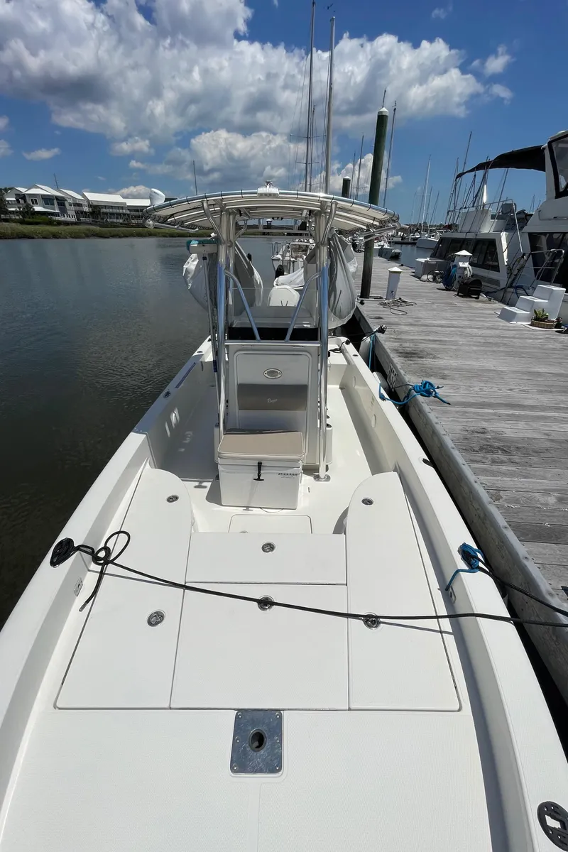 Slide: The Image of 2012 Ranger 2410 Bay Ranger boat docked at marina under blue sky. - 21