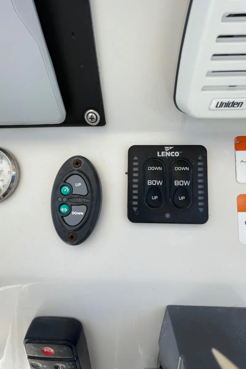 Slide: The Image of Control panel of a 2012 Ranger 2410 Bay Ranger boat with Lenco trim tab switches. - 7