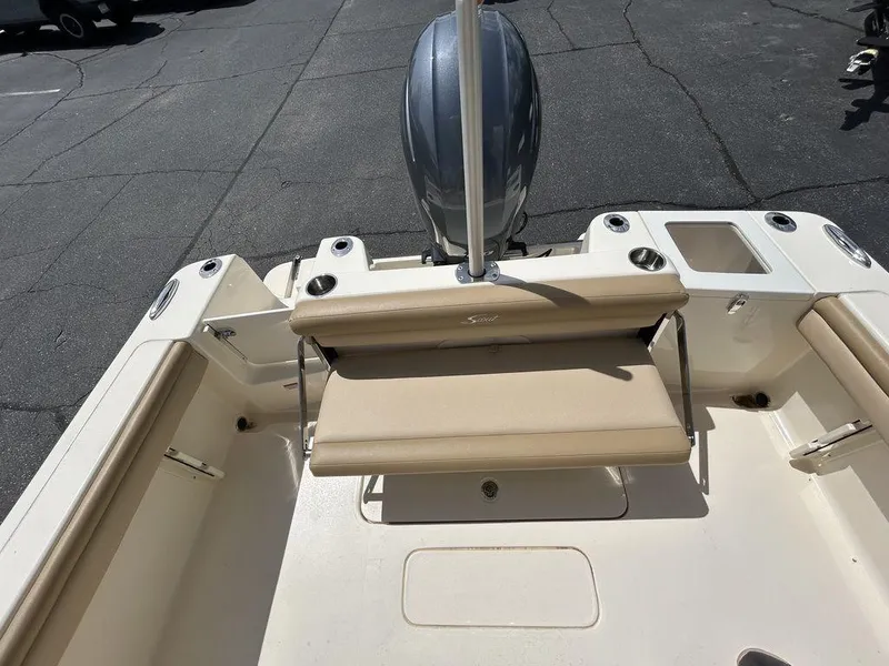 Slide: The Image of 2021 Scout 215 XSF boat interior with seating and motor, viewed from above. - 12