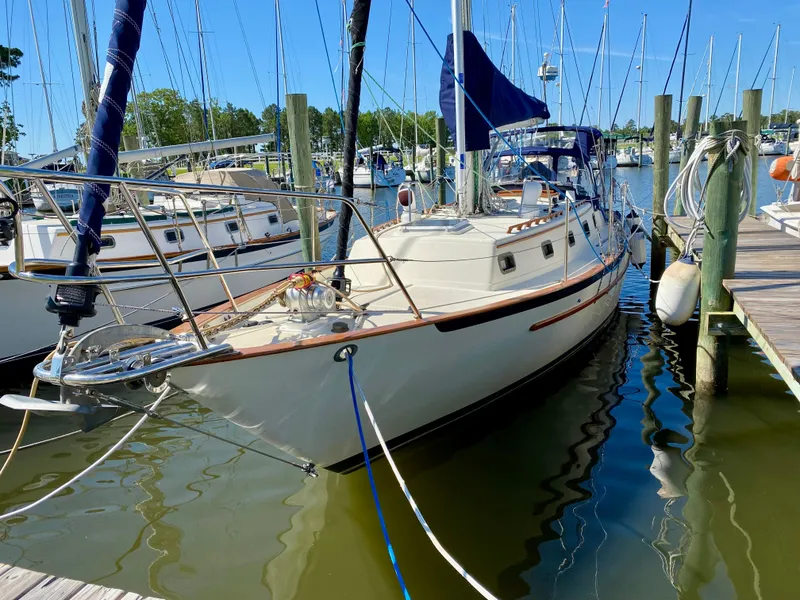The Image of 1998 Pacific Seacraft 37 sailboat docked at marina, surrounded by other boats. - 0