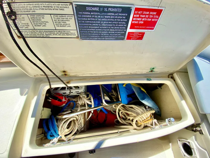 Slide: The Image of Storage compartment on a 1998 Pacific Seacraft 37 sailboat, containing ropes and equipment. - 13