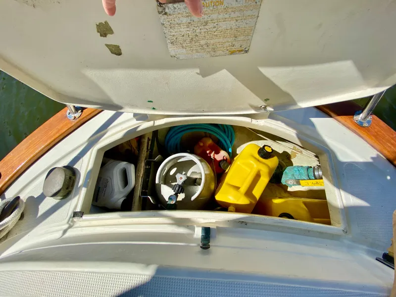 Slide: The Image of Storage compartment on a 1998 Pacific Seacraft 37 sailboat with various equipment and supplies. - 14