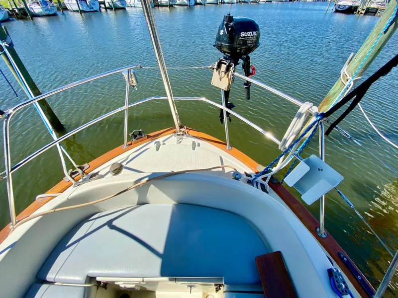 Slide: The Image of Cockpit of 1998 Pacific Seacraft 37 sailboat with Suzuki outboard motor, docked in marina. - 15