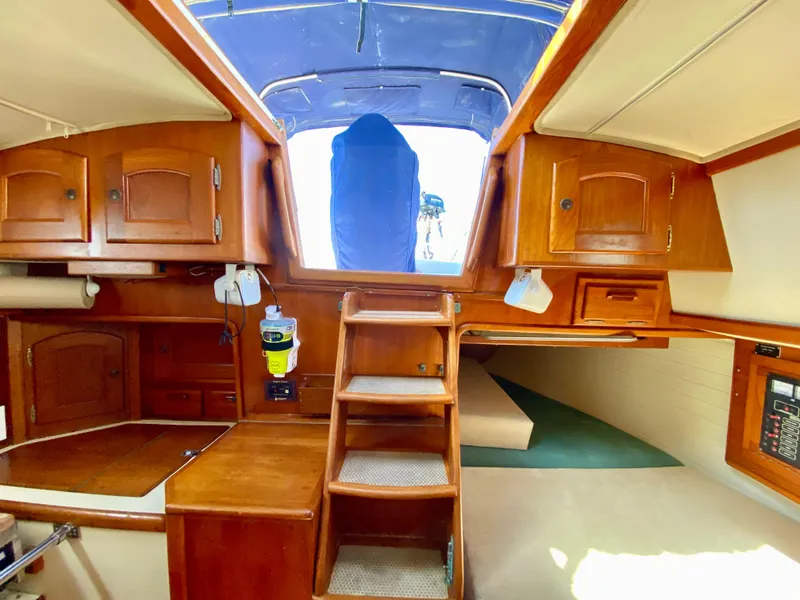 Slide: The Image of Interior of 1998 Pacific Seacraft 37 sailboat with wooden cabinetry and steps. - 16