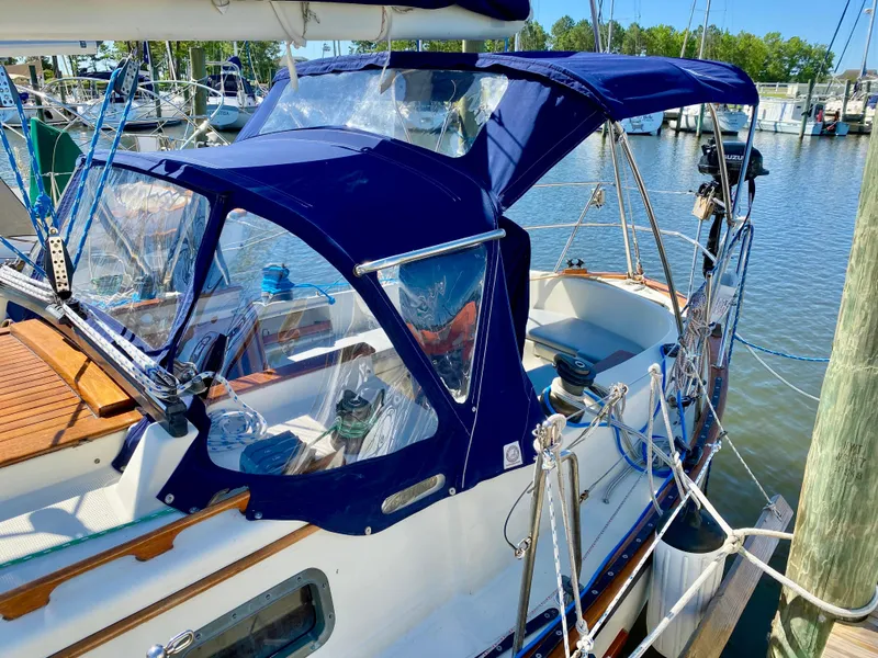 Slide: The Image of 1998 Pacific Seacraft 37 sailboat docked with blue canvas cover. - 2