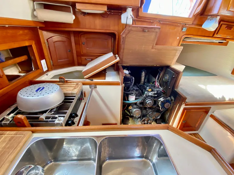 Slide: The Image of Interior of 1998 Pacific Seacraft 37 sailboat showing kitchen and engine compartment. - 25