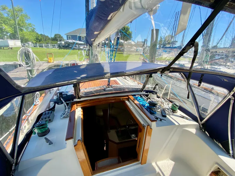 Slide: The Image of Cockpit view of a 1998 Pacific Seacraft 37 sailboat with open hatch and clear canopy. - 3