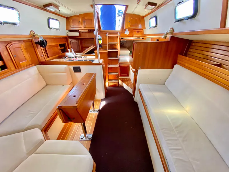 Slide: The Image of Interior of 1998 Pacific Seacraft 37 sailboat with wooden finish and white seating. - 31