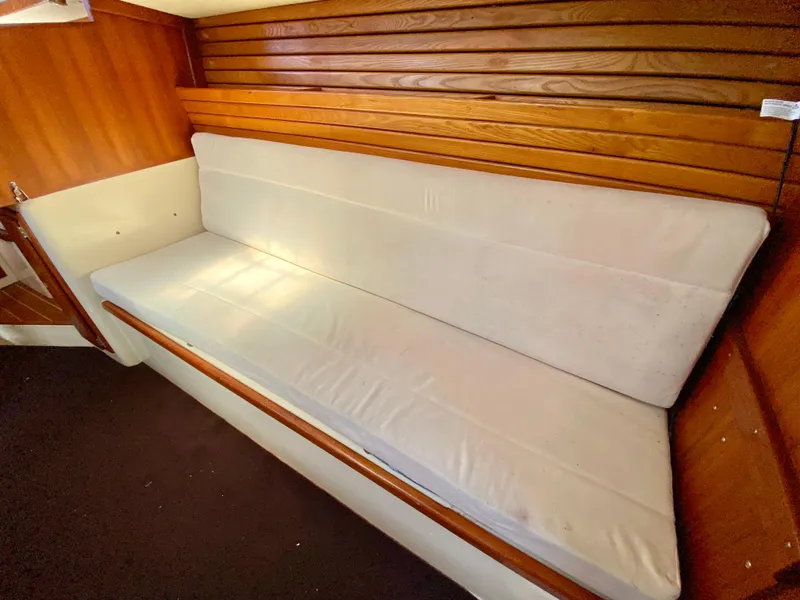 Slide: The Image of Interior of 1998 Pacific Seacraft 37 sailboat with cushioned seating and wooden paneling. - 32