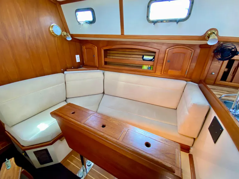 Slide: The Image of Interior of 1998 Pacific Seacraft 37 sailboat with cozy seating and wooden accents. - 33