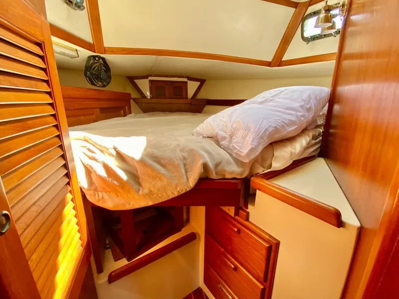 Slide: The Image of Cozy cabin interior of 1998 Pacific Seacraft 37 sailboat with wooden furnishings. - 34