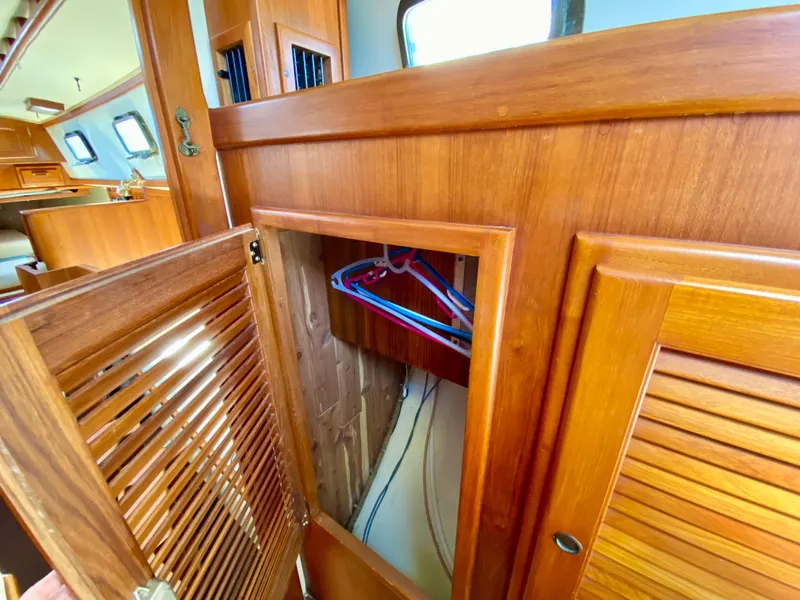Slide: The Image of Interior of 1998 Pacific Seacraft 37 sailboat with wooden cabinetry and closet. - 36