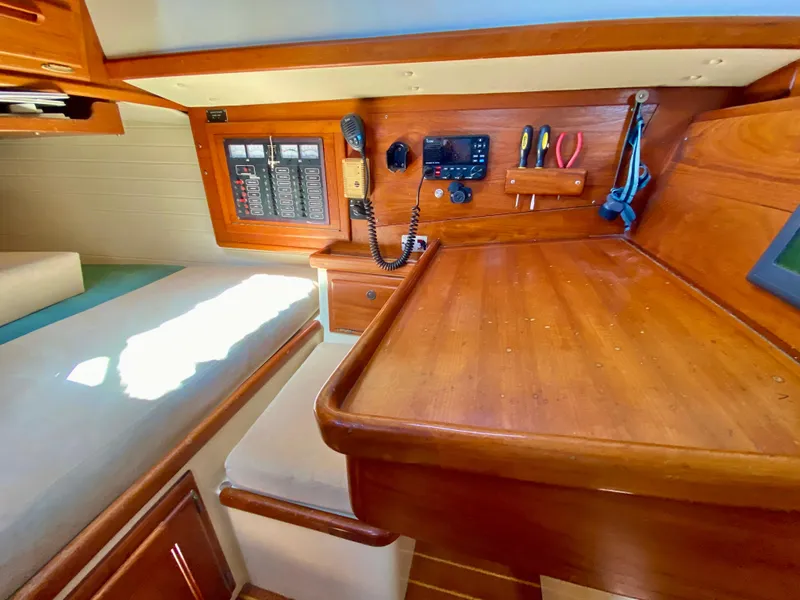 Slide: The Image of Navigation station in 1998 Pacific Seacraft 37 sailboat with control panel and tools. - 41
