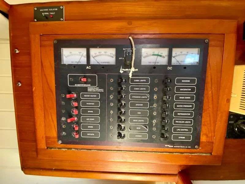 Slide: The Image of Electrical panel on a 1998 Pacific Seacraft 37 sailboat, featuring AC and DC controls. - 42
