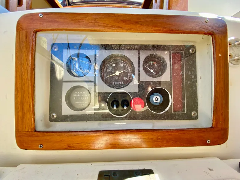 Slide: The Image of Control panel of a 1998 Pacific Seacraft 37 sailboat with wooden frame. - 43