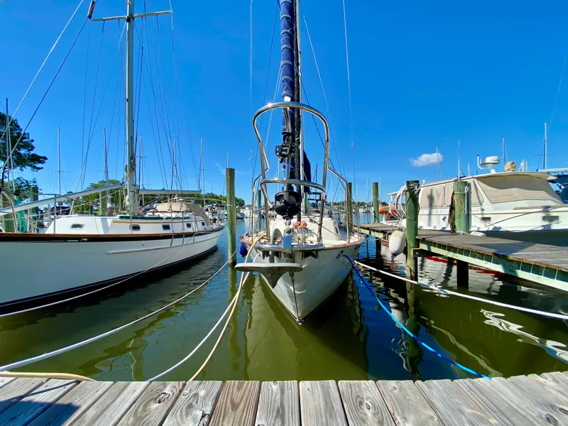 Slide: The Image of Pacific Seacraft 37 sailboat docked at marina, 1998 model, clear blue sky. - 44