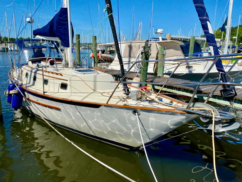 Slide: The Image of 1998 Pacific Seacraft 37 sailboat docked in a marina under clear blue skies. - 46