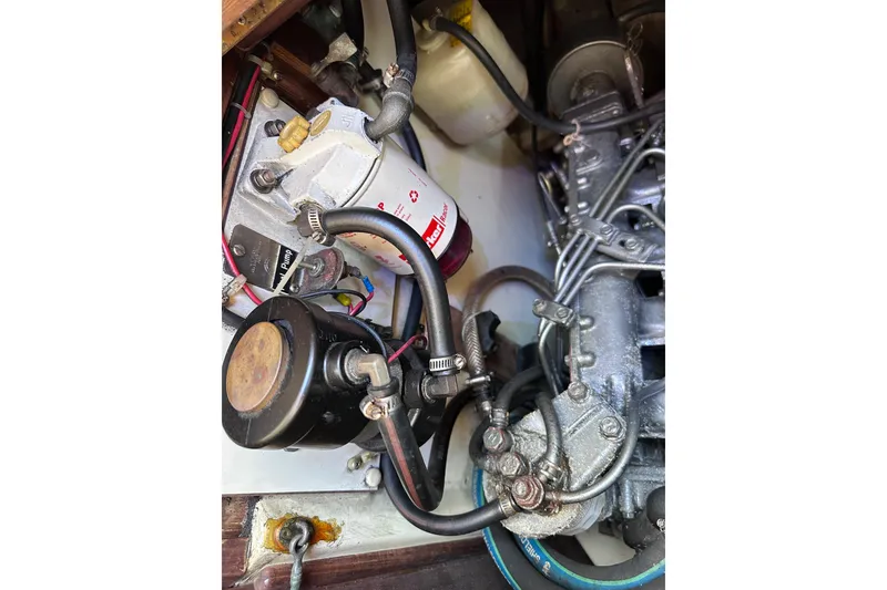 Slide: The Image of Engine compartment of a 1998 Pacific Seacraft 37 sailboat, showing mechanical components. - 49