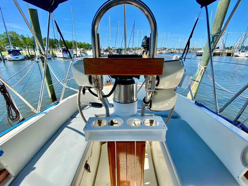 Slide: The Image of Cockpit view of a 1998 Pacific Seacraft 37 sailboat docked at a marina. - 6