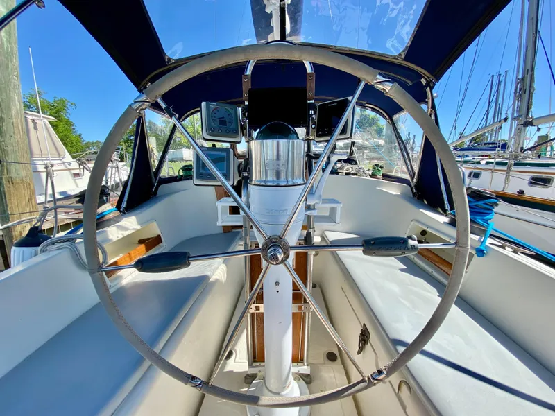 Slide: The Image of Steering wheel of a 1998 Pacific Seacraft 37 sailboat, docked in a marina. - 8