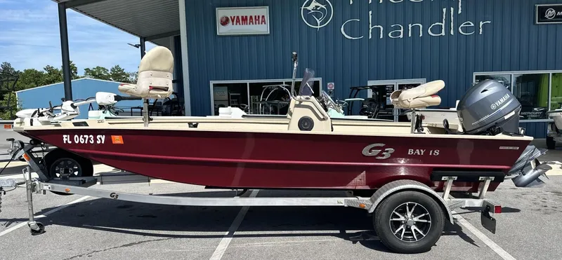 The Image of 2020 G3 Bay 18 boat on trailer, parked outside dealership, featuring Yamaha engine. - 0