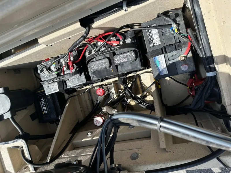 Slide: The Image of Battery compartment of a 2020 G3 Bay 18 boat with wiring and connections. - 13