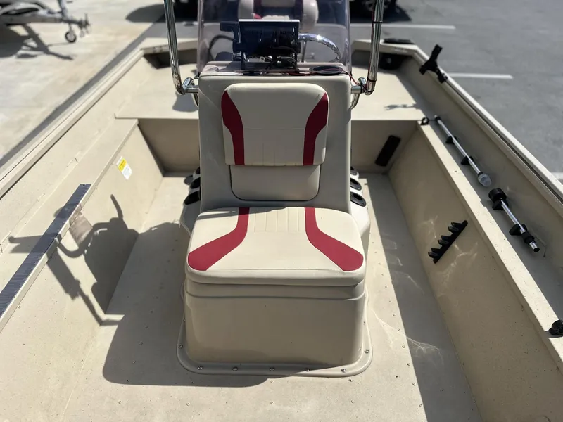 Slide: The Image of 2020 G3 Bay 18 boat interior with beige and red seating, steering console, and rod holders. - 8