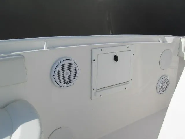 Slide: The Image of 2023 Edgewater 245CC boat interior with speakers and storage compartment. - 10