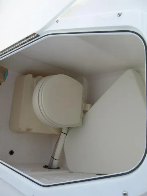 Slide: The Image of 2023 Edgewater 245CC boat interior with compact marine toilet. - 11