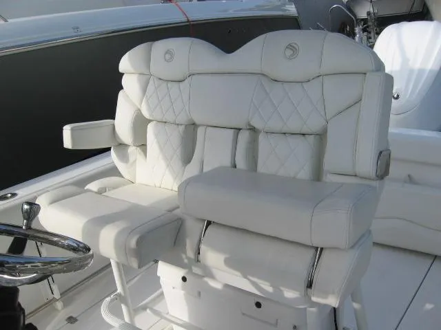 Slide: The Image of Luxurious seating on 2023 Edgewater 245CC boat with white quilted upholstery. - 7