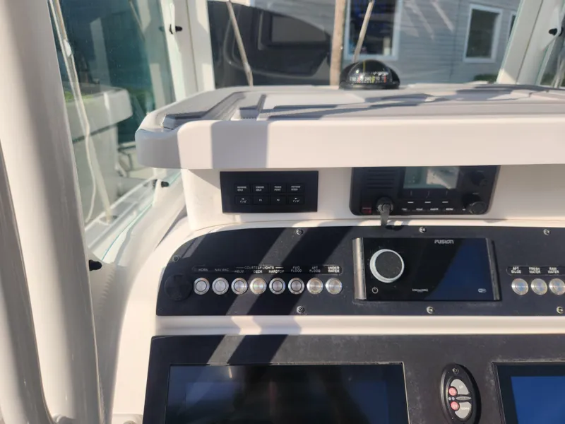 Slide: The Image of 2021 Everglades 243 Center Console dashboard with navigation controls and display screens. - 14