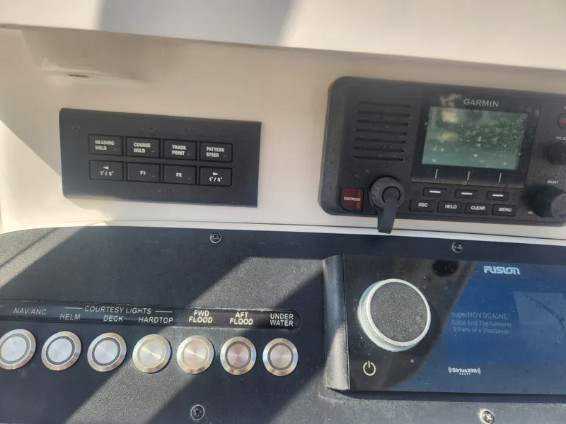 Slide: The Image of Control panel of 2021 Everglades 243 Center Console with Garmin and Fusion systems. - 18