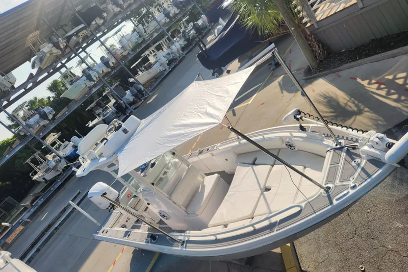 Slide: The Image of 2021 Everglades 243 Center Console boat with canopy, docked in a marina. - 20