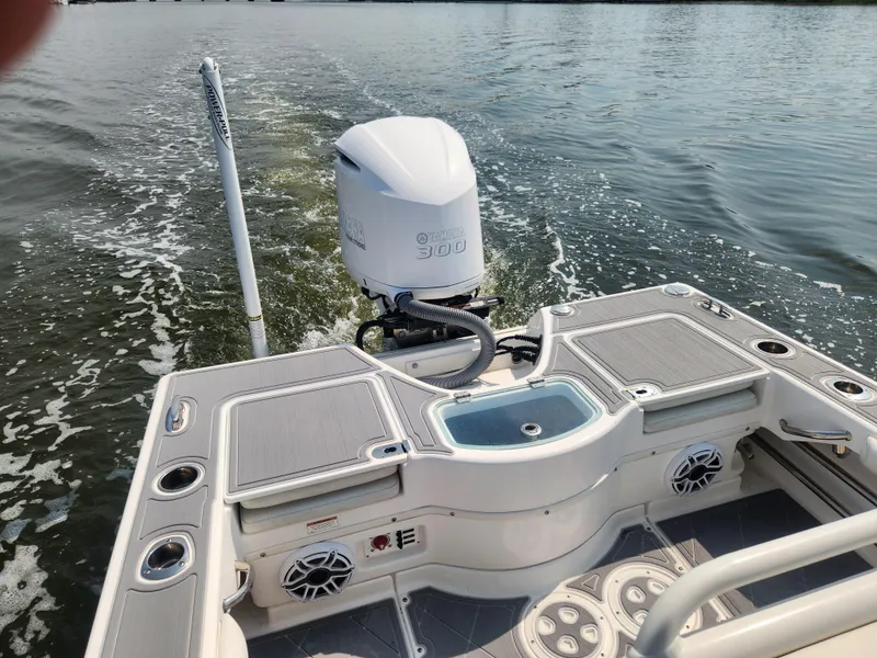 Slide: The Image of 2021 Everglades 243 Center Console boat with outboard motor on calm water. - 3