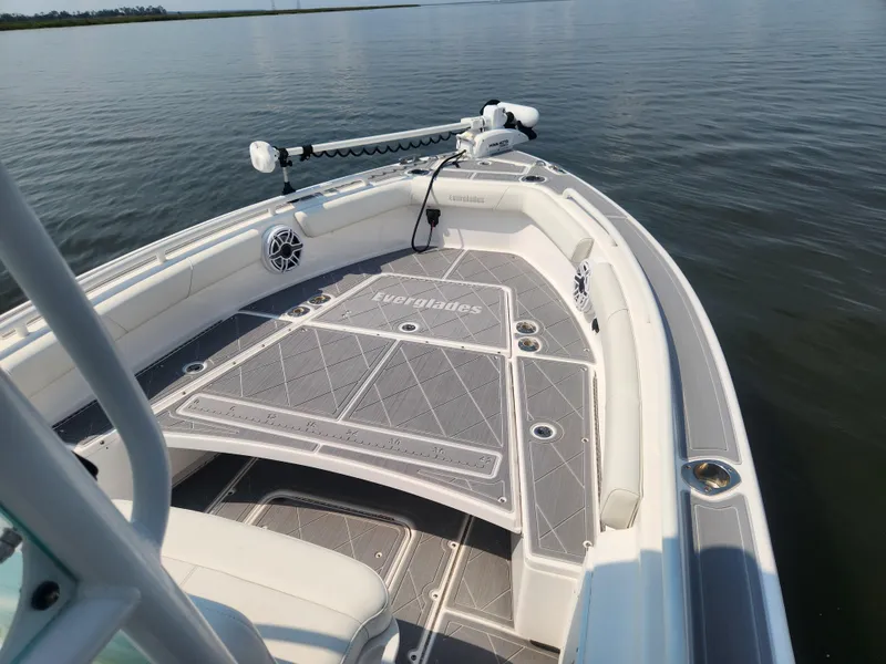 Slide: The Image of 2021 Everglades 243 Center Console boat on calm water, featuring spacious deck and modern design. - 4