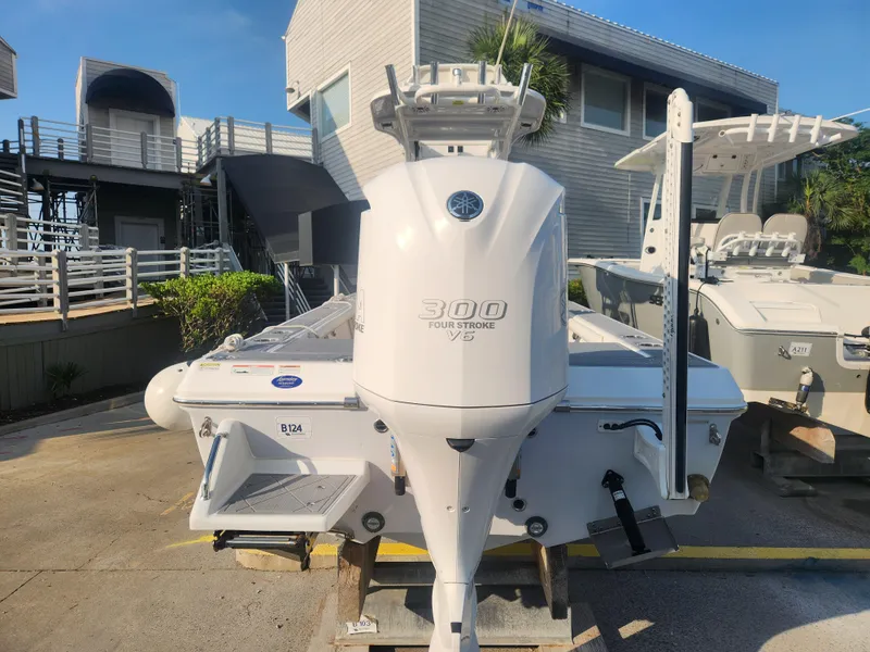 Slide: The Image of 2021 Everglades 243 Center Console boat with 300 horsepower engine, docked outdoors. - 8