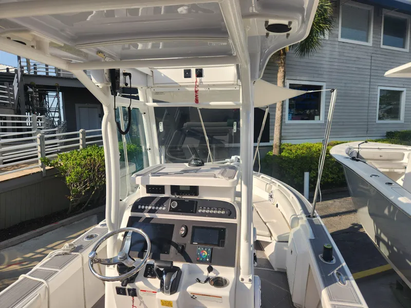 Slide: The Image of 2021 Everglades 243 Center Console boat interior with steering wheel and control panel. - 9