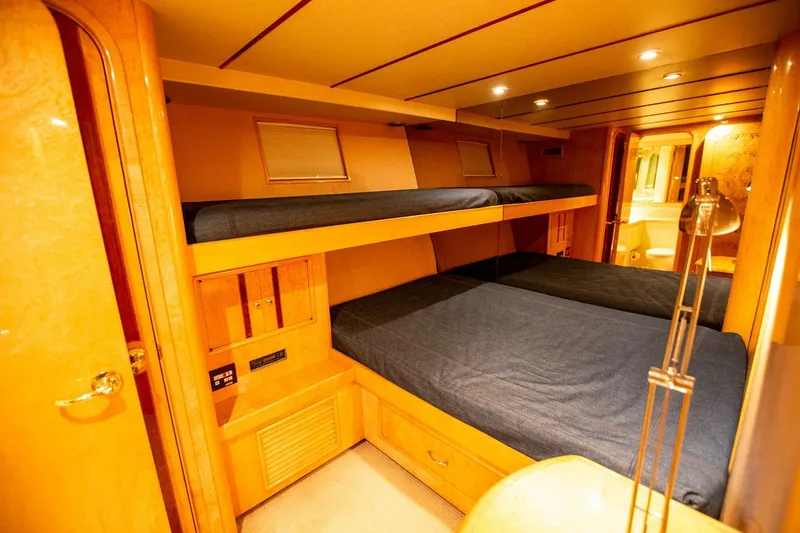 Slide: The Image of Luxurious 1999 Tarrab Motor Yacht cabin with cozy bunk beds and warm lighting. - 13