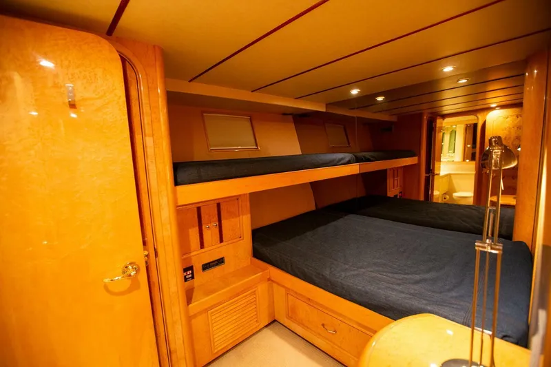 Slide: The Image of Luxurious cabin interior of 1999 Tarrab Motor Yacht with wooden finish and cozy bedding. - 14